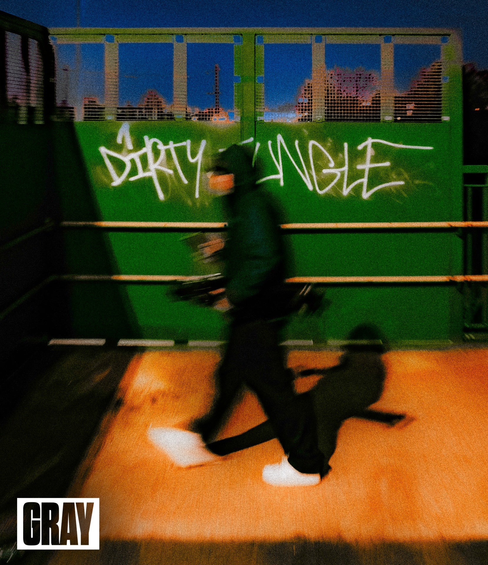 Person walking with a child on a sidewalk with graffiti in the background